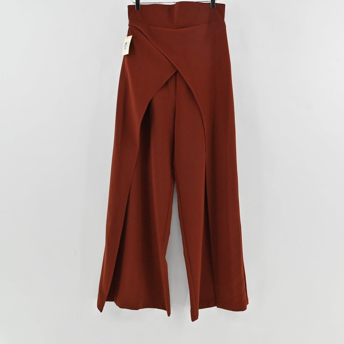 Lynn's Closet Boutique rust-brown wide-leg trousers with unique front-slit detailing hanging on a hanger