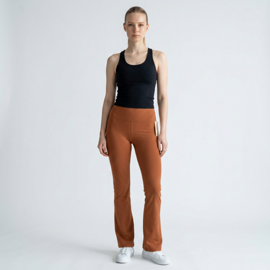 Model wearing Lynn's Closet Boutique Lululemon high-rise rust flare Groove pants with a black tank top