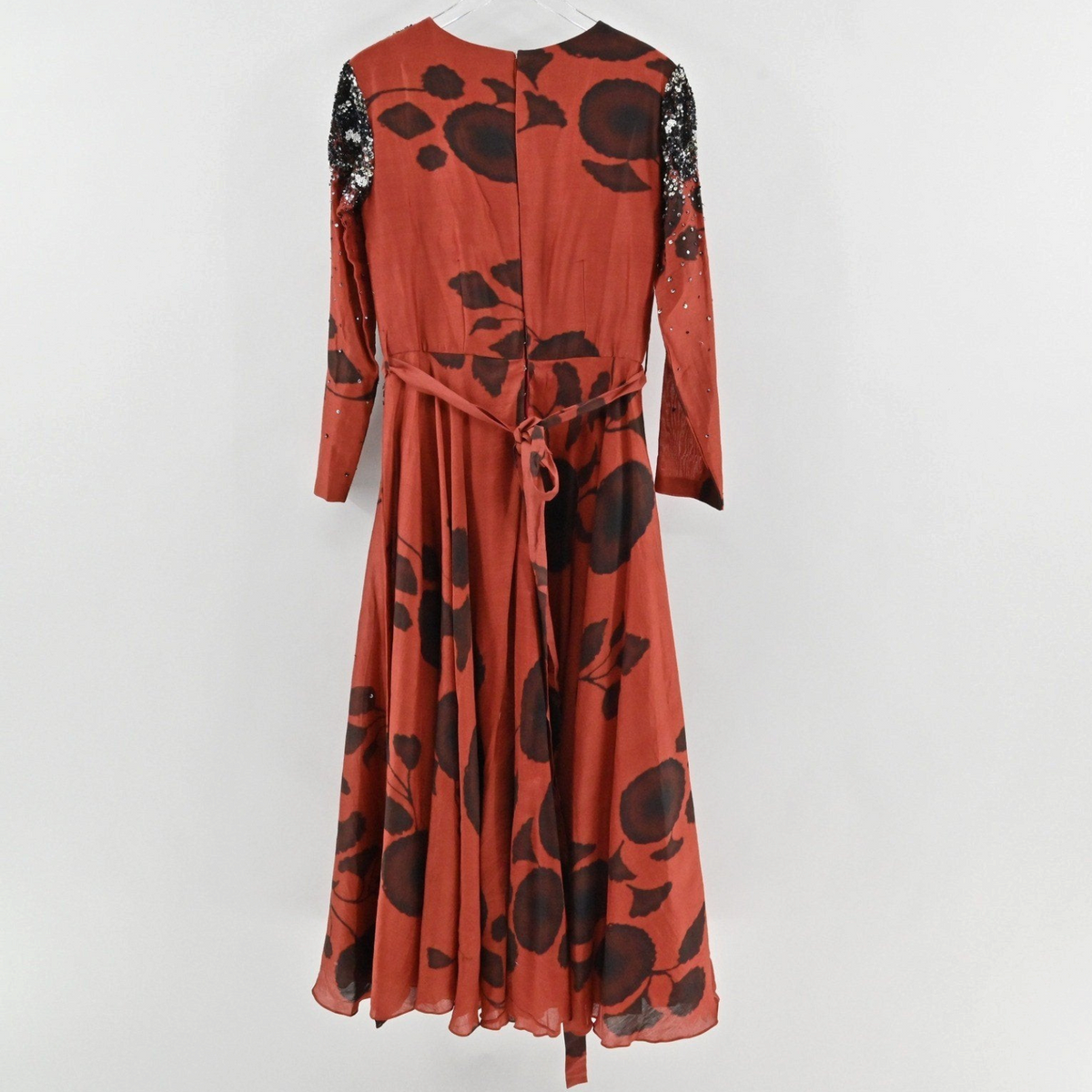 Lynn's Closet Boutique rust and black floral maxi dress with beaded sequin shoulders and a waist tie, back view.