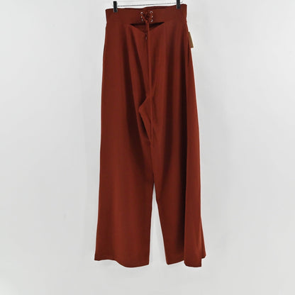 Lynn's Closet Boutique Andrea Iyamah rust-brown wide-leg trousers with lace-up back detail hanging on a hanger