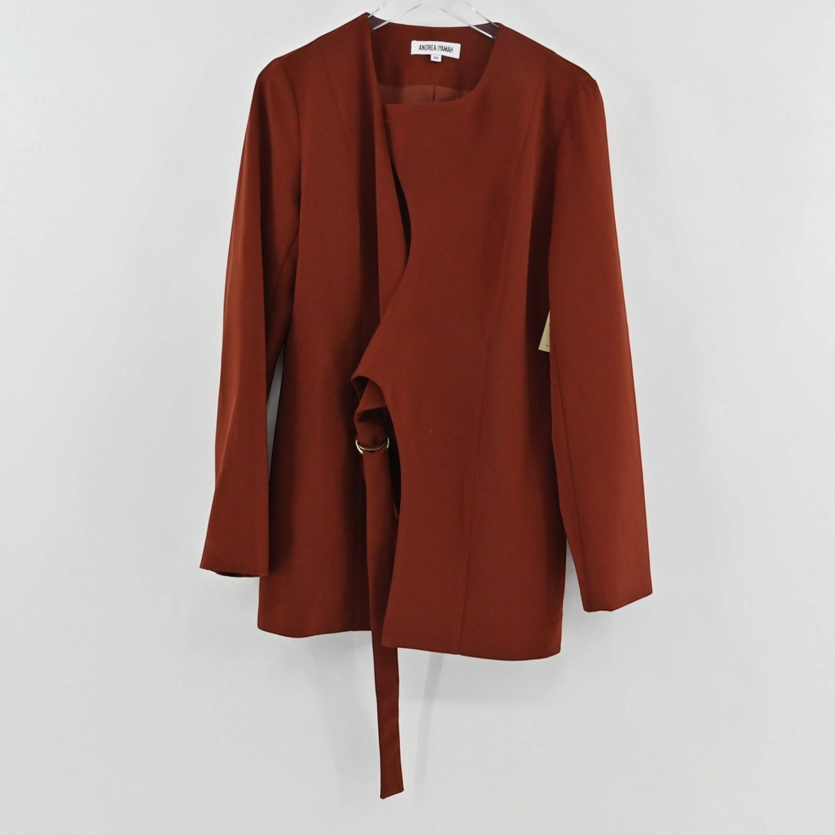 Lynn's Closet Boutique Andrea Iyamah rust-brown collarless wrap blazer with tie-waist belt hanging on a hanger