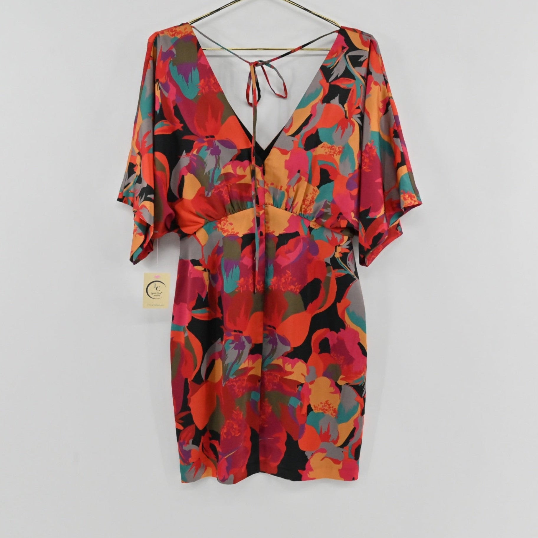 Lynn's Closet Boutique Aidan Mattox satin mini dress with vibrant floral print, V-neck, and kimono sleeves.