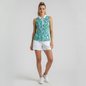 Model wearing a Lynn's Closet Boutique sleeveless polo with a blue and green tropical print and white collar