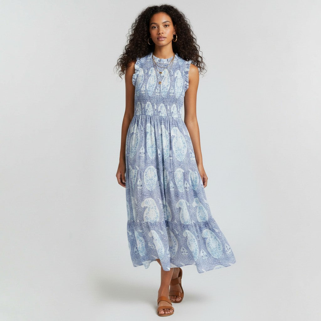 Model wearing Lynn's Closet Boutique blue paisley print smocked maxi dress with ruffled shoulders and tiered skirt.