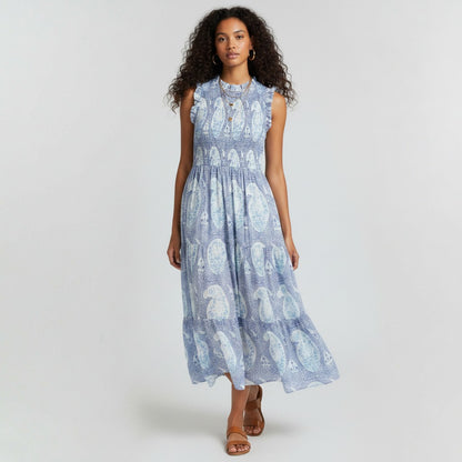 Model wearing Lynn's Closet Boutique blue paisley print smocked maxi dress with ruffled shoulders and tiered skirt.