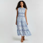 Model wearing Lynn's Closet Boutique blue paisley print smocked maxi dress with ruffled shoulders and tiered skirt.