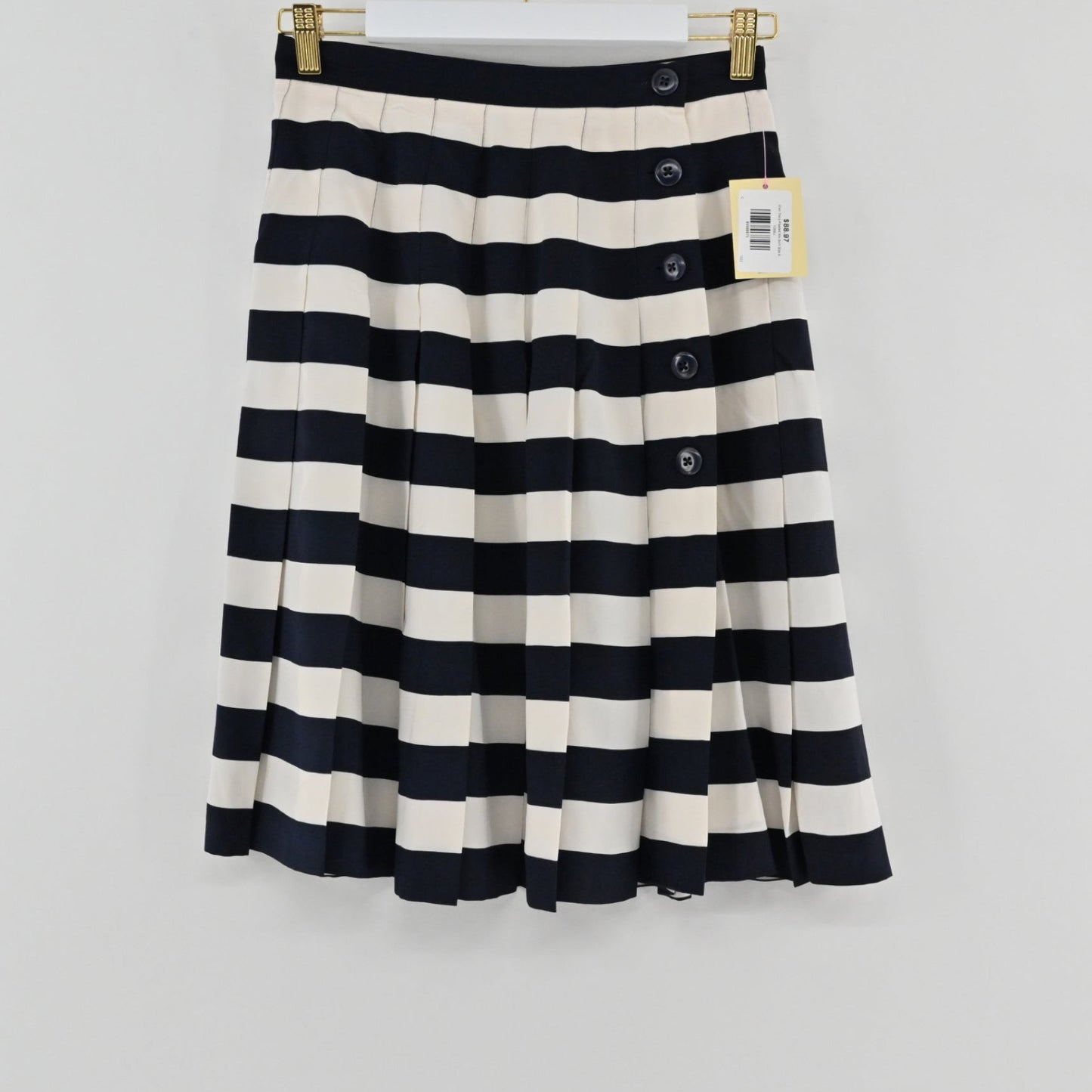 Lynn's Closet Boutique Ellen Tracy knee-length pleated skirt in navy and cream stripes with side button detail.