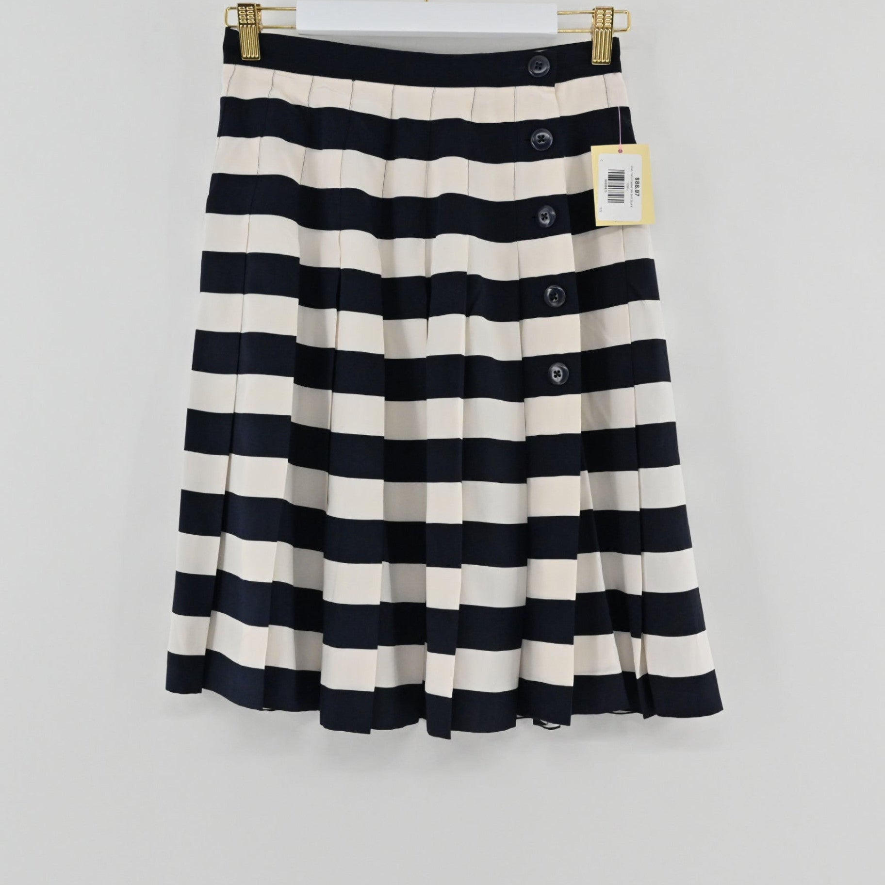 Lynn's Closet Boutique Ellen Tracy knee-length pleated skirt in navy and cream stripes with side button detail.