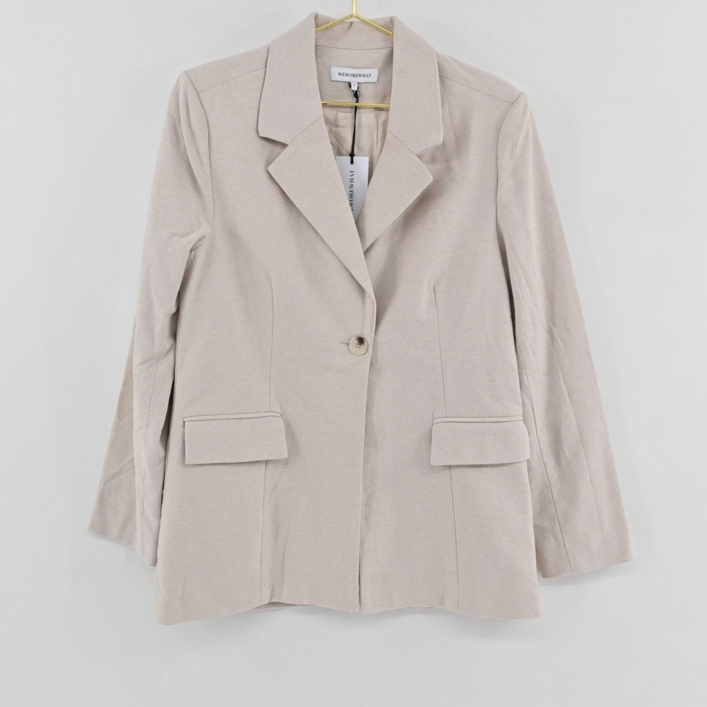 Lynn's Closet Boutique tan tweed blazer with notched lapels, single-button closure, and flap pockets, size S.