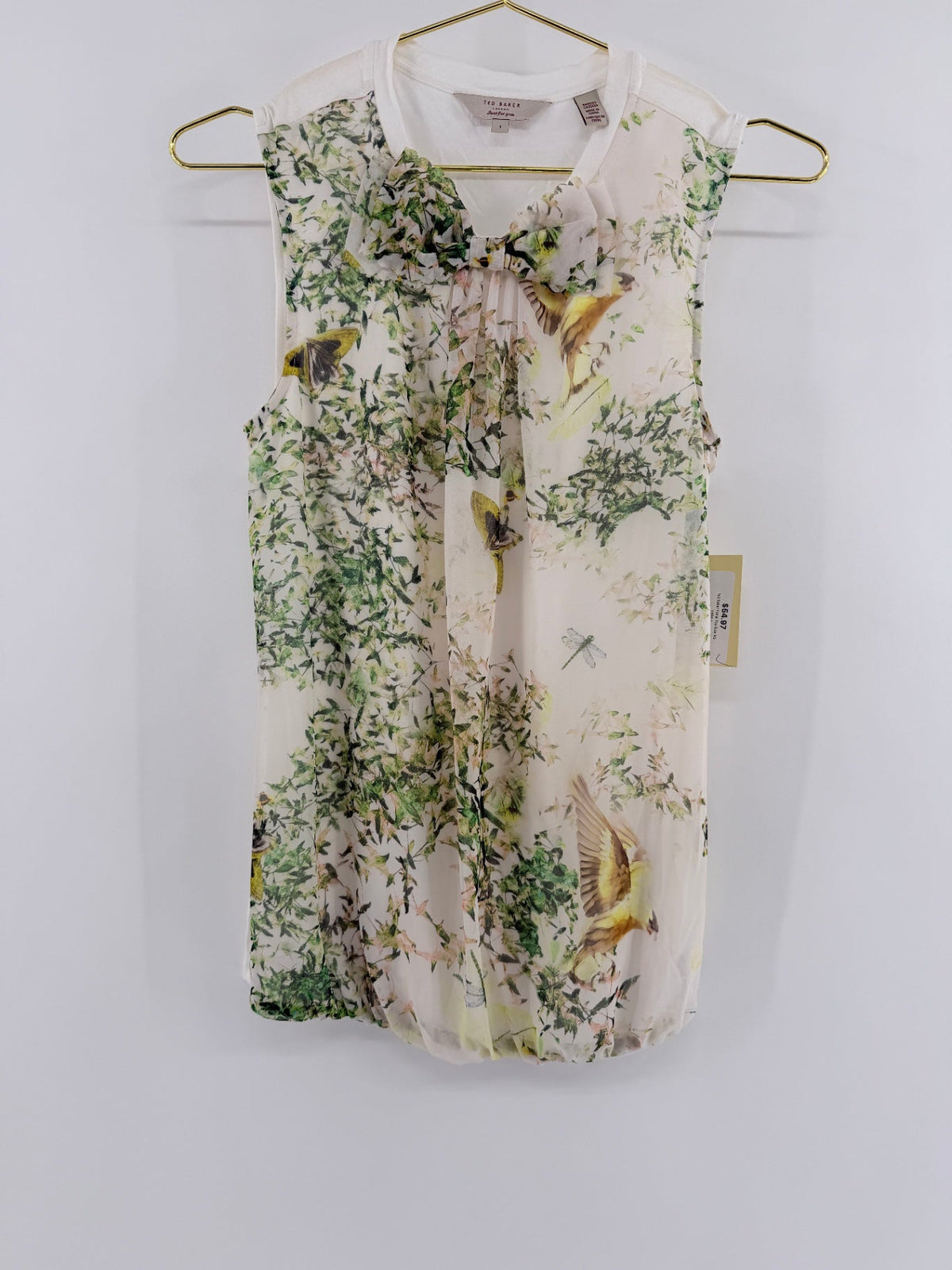 Lynn's Closet Boutique Ted Baker sleeveless floral top with bird print, cream backdrop, and bow neckline detail.