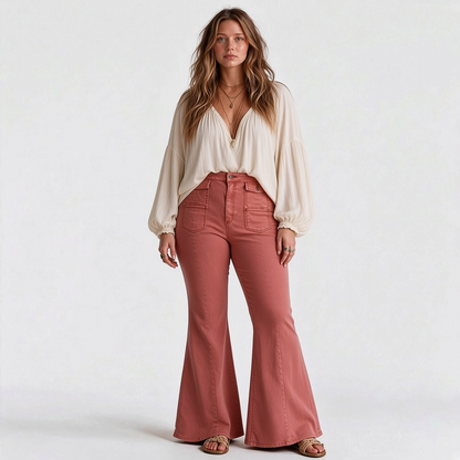 Model wearing Lynn's Closet Boutique Free People terra cotta wide-leg flare pants with front button-flap pockets.