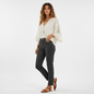 Model wearing Lynn's Closet Boutique Thakoon slate grey cropped jeans with a white bohemian blouse and brown sandals.