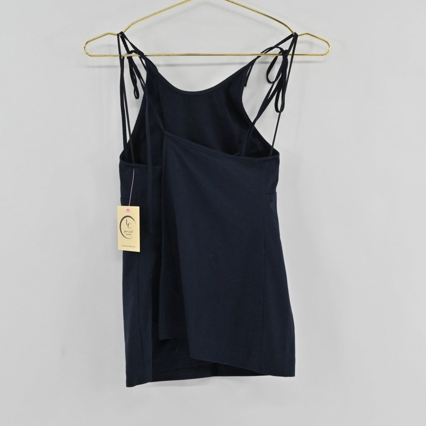 Lynn's Closet Boutique Theory Hartmann navy ribbed sleeveless top with adjustable tie-shoulder straps on a hanger