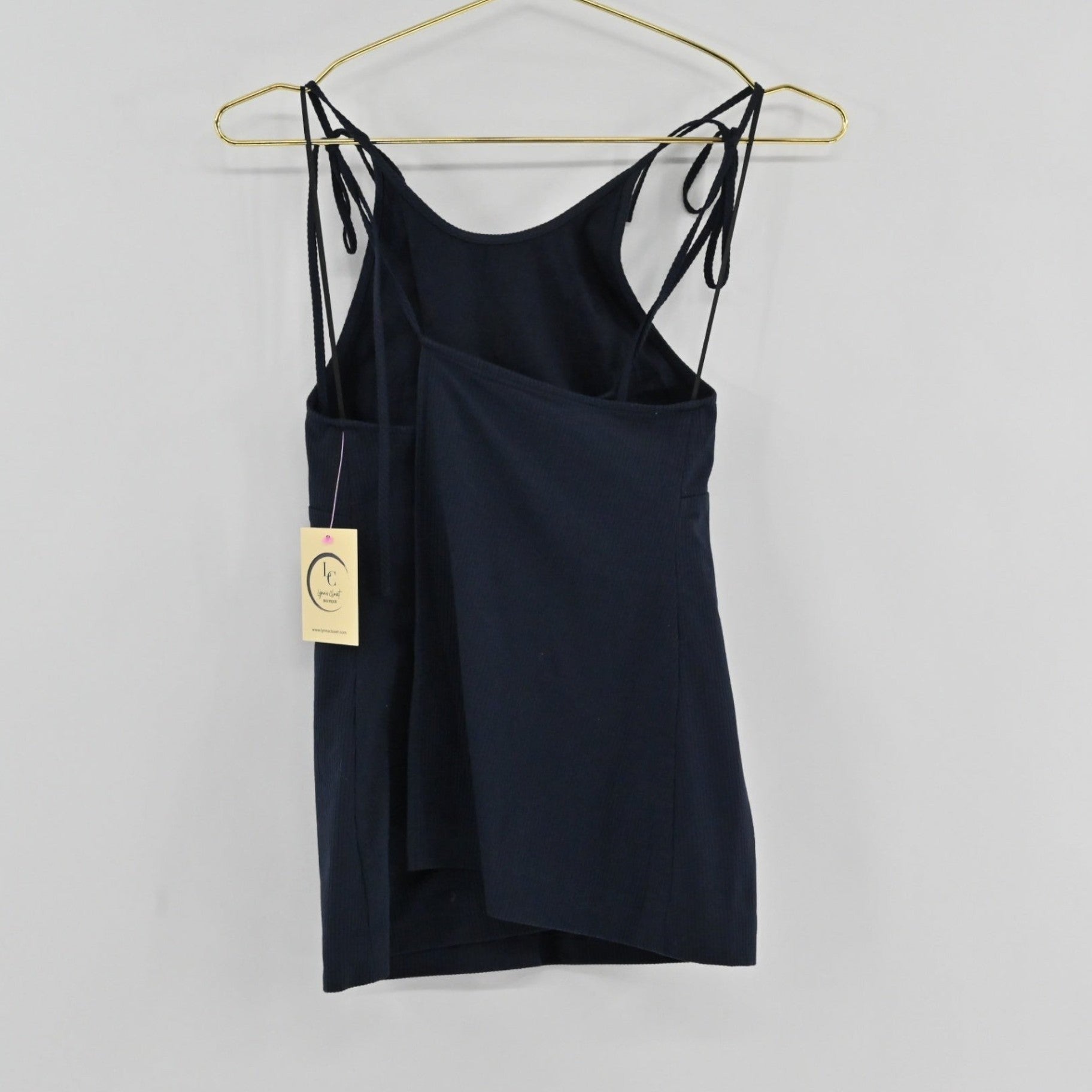 Lynn's Closet Boutique Theory Hartmann navy ribbed sleeveless top with adjustable tie-shoulder straps on a hanger