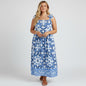 Model wearing a Lynn's Closet Boutique blue and white tile print caftan dress with tie-shoulder straps.