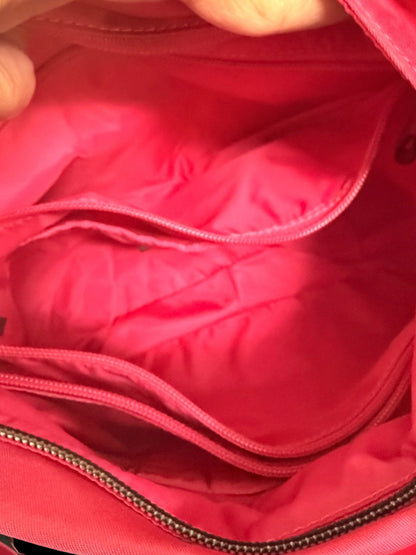 Lynn's Closet Boutique Tumi Voyageur crossbody bag interior showing hot pink nylon lining and zippered compartments.