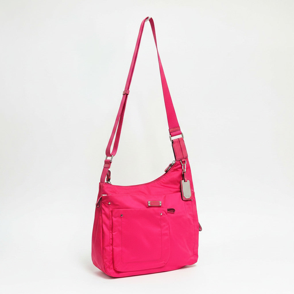 Lynn's Closet Boutique Tumi Voyageur hot pink nylon crossbody bag with adjustable strap and silver hardware.