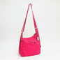Lynn's Closet Boutique Tumi Voyageur hot pink nylon crossbody bag with adjustable strap and silver hardware.