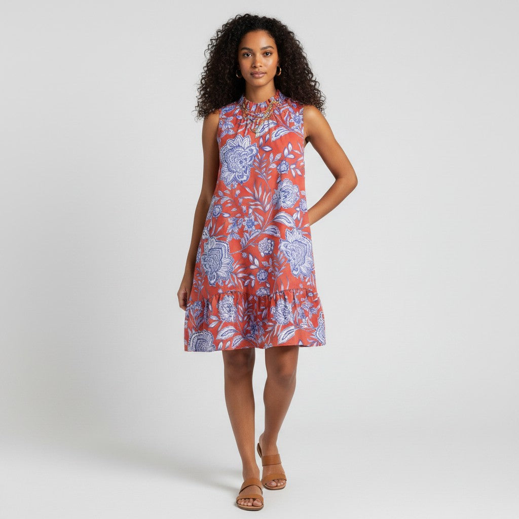 Model wearing a Lynn's Closet Boutique Tyler Boe sleeveless dress in rust orange with a blue floral paisley print.