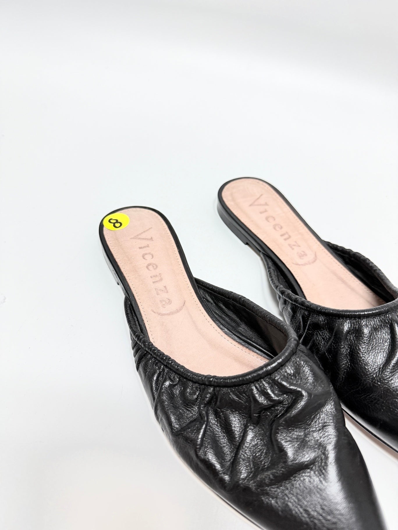 Lynn's Closet Boutique Vicenza black leather mules with ruched texture and pointed toe, size 8 slip-on flats.