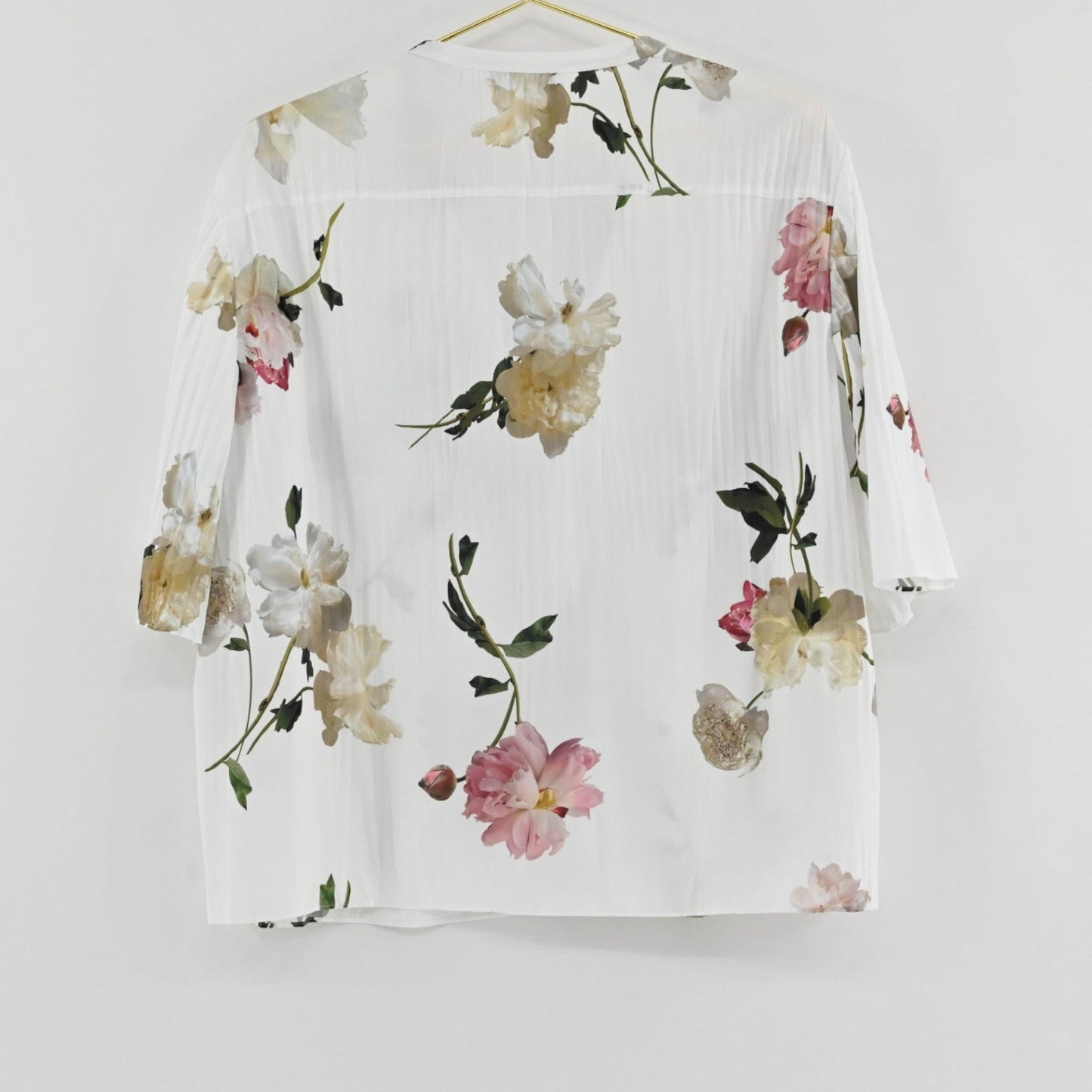 Lynn's Closet Boutique Vince floral top in white with pink and green botanical print, textured fabric, back view.