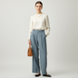 Model wearing Lynn's Closet Boutique Vince blue-grey wide-leg trousers with a cream silk blouse and tan handbag.