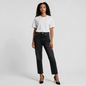 Model wearing Lynn's Closet Boutique Re/Done 70's Stove Pipe jeans in washed black with a white t-shirt and heels