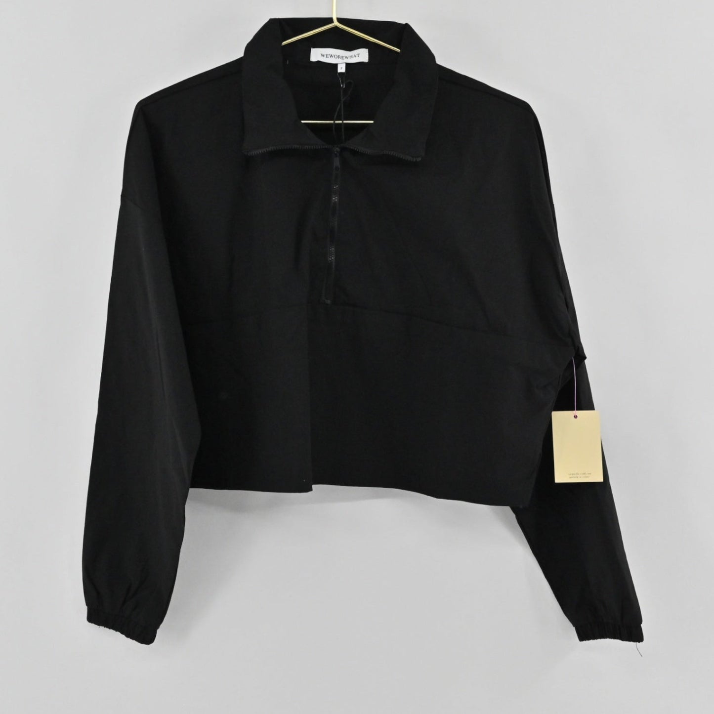 Lynn's Closet Boutique Revolve WeWoreWhat black cropped jacket with a half-zip front, collar, and elasticated cuffs.