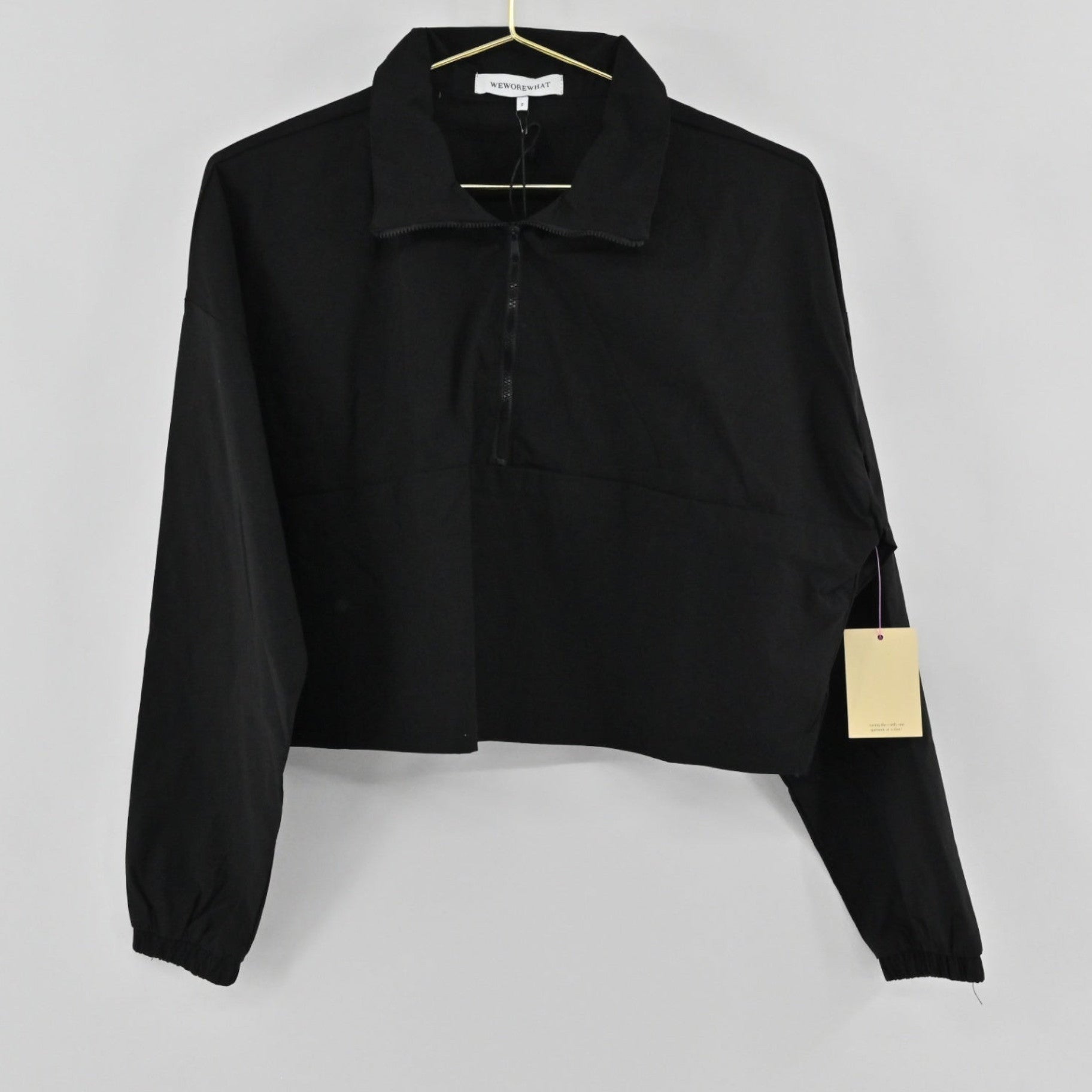 Lynn's Closet Boutique Revolve WeWoreWhat black cropped jacket with a half-zip front, collar, and elasticated cuffs.