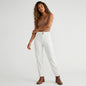 Model wearing Lynn's Closet Boutique white corduroy cargo pants with side zippers and a brown tank top.