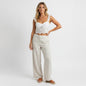Lynn's Closet Boutique Anthropologie white eyelet cropped corset top with ruffled straps worn with linen trousers