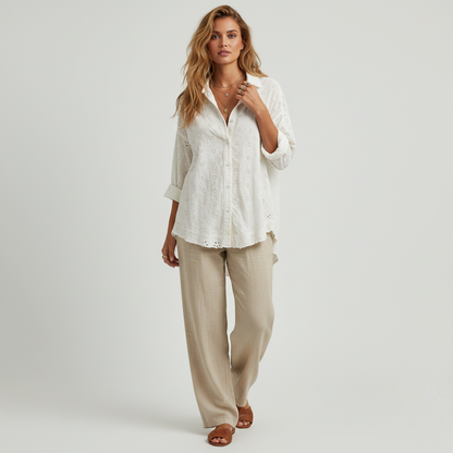 Lynn's Closet Boutique Free People white eyelet button-down shirt worn by a model with beige linen trousers