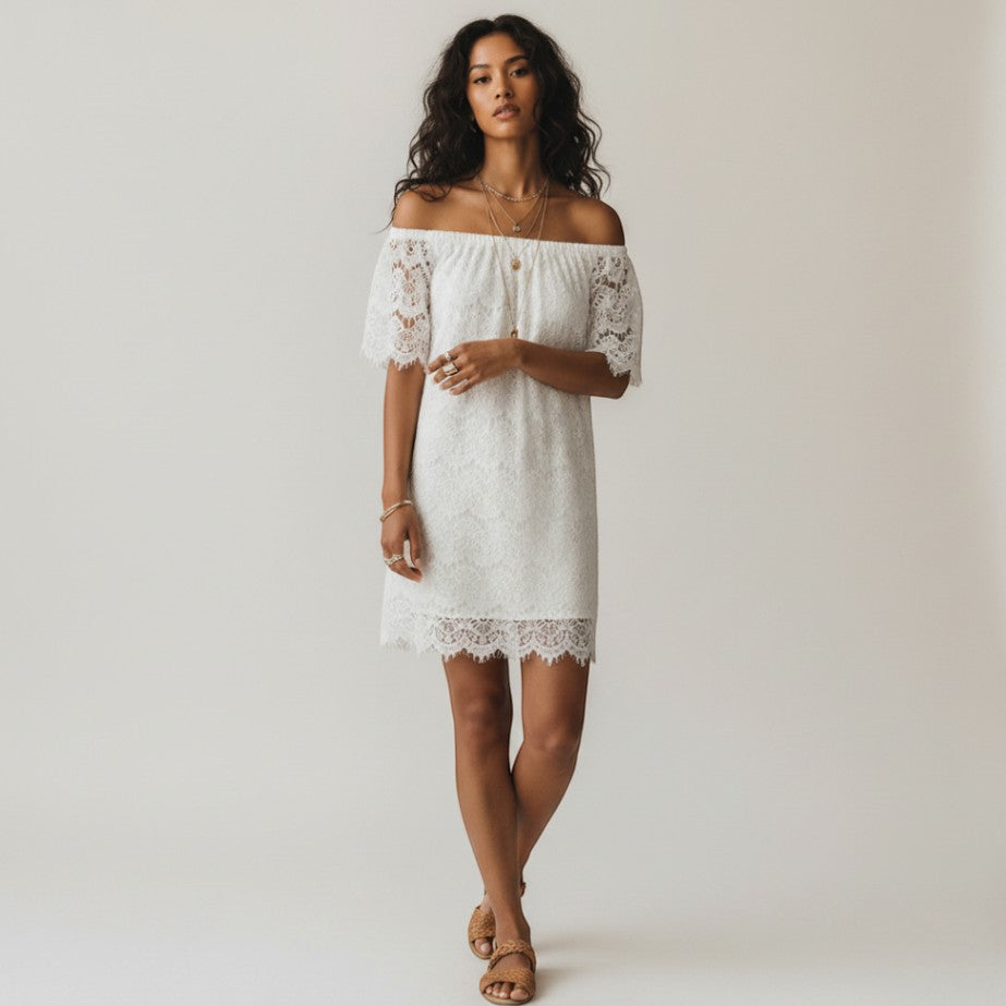 Model wearing a white City Chic off-the-shoulder lace dress with scalloped hem from Lynn's Closet Boutique