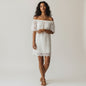 Model wearing a white City Chic off-the-shoulder lace dress with scalloped hem from Lynn's Closet Boutique