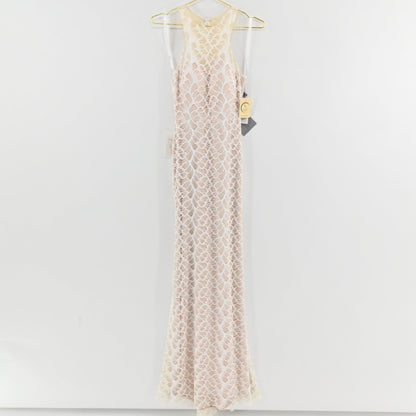 Lynn's Closet Boutique white floor-length lace gown with a high-neck racerback design and intricate leaf-pattern overlay.