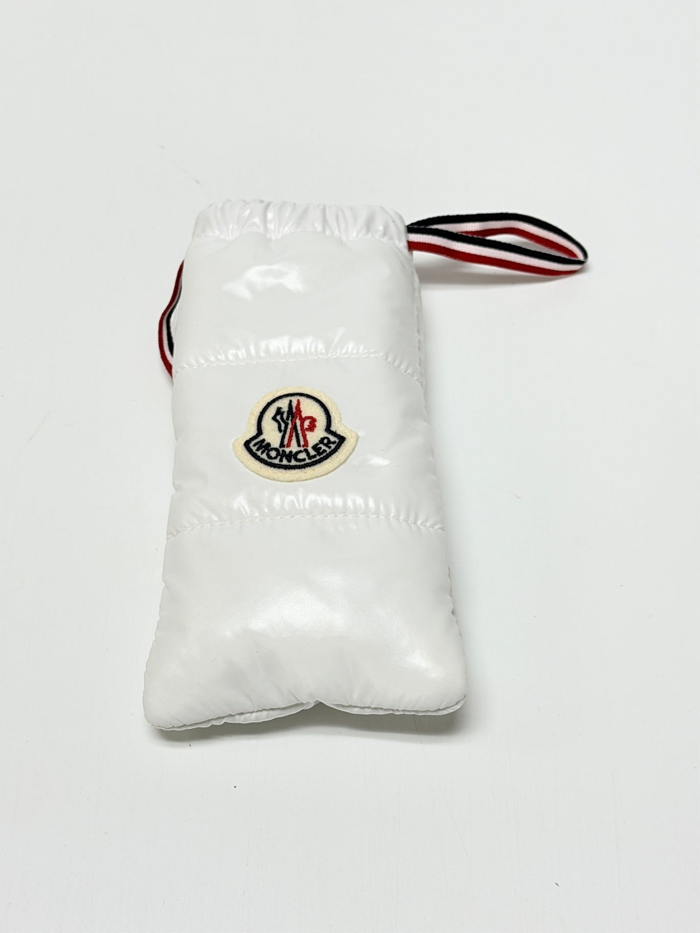 Lynn's Closet Boutique white quilted Moncler sunglasses pouch with signature logo patch and tricolor striped strap