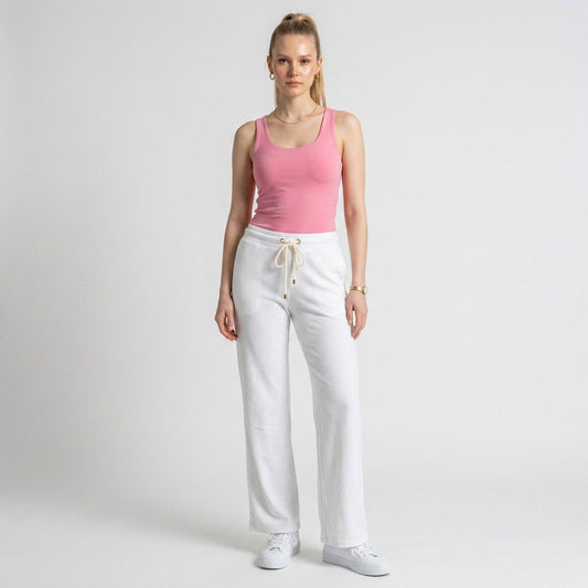 Model wearing Lynn's Closet Boutique white textured wide-leg pants with a drawstring waist and gold-tone hardware.