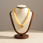 Lynn's Closet Boutique chunky yellow acrylic bead necklace with a polished gold-tone heart pendant on a display bust.