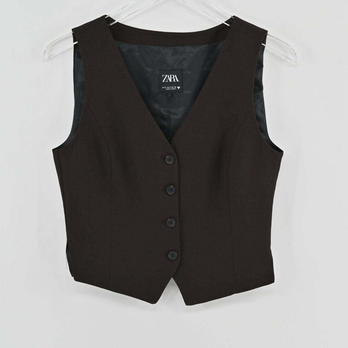 Lynn's Closet Boutique Zara brown tailored vest with a V-neckline and button-front closure on a clear hanger.