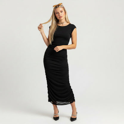 Model wearing a black Bar III ruched maxi dress from Lynn's Closet Boutique, featuring a form-fitting silhouette.