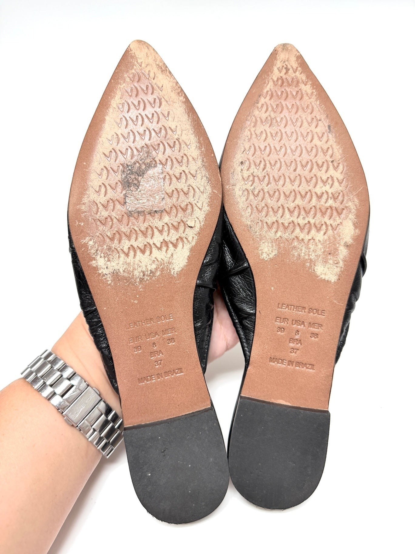 Lynn's Closet Boutique Vicenza black leather mules showing the textured leather soles and pointed-toe design.