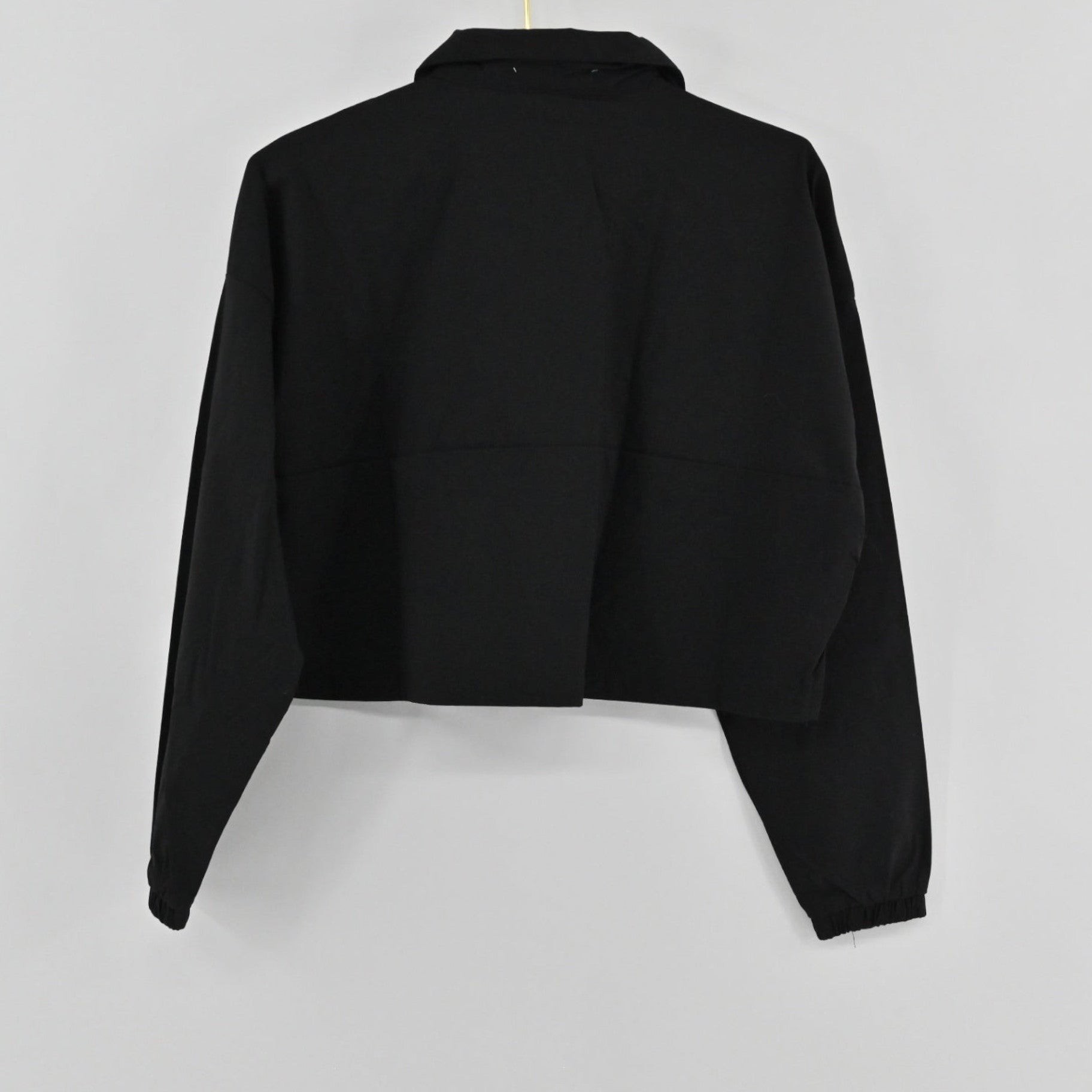 Lynn's Closet Boutique WeWoreWhat black cropped jacket with a collar, half-zip front, and elasticated cuffs.