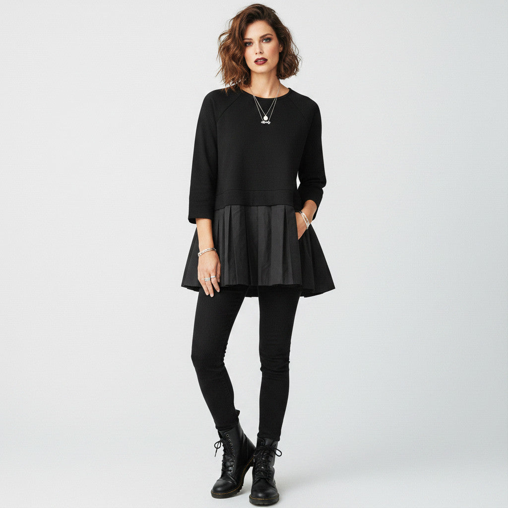 Lynn's Closet Boutique black COS peplum top with crew neck and 3/4 sleeves, size M. Features a pleated skirt detail.