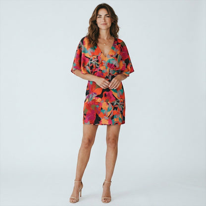 Lynn's Closet Boutique Aidan Mattox satin mini dress with vibrant floral print, V-neck, and kimono sleeves on a model