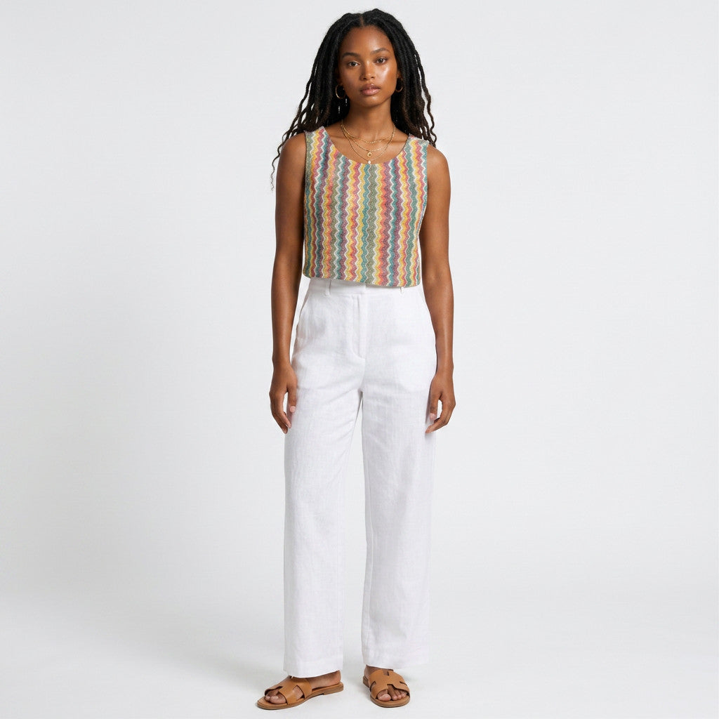 Model wearing Lynn's Closet Boutique Anthropologie Verb sleeveless top with a multi-colored chevron textured pattern.