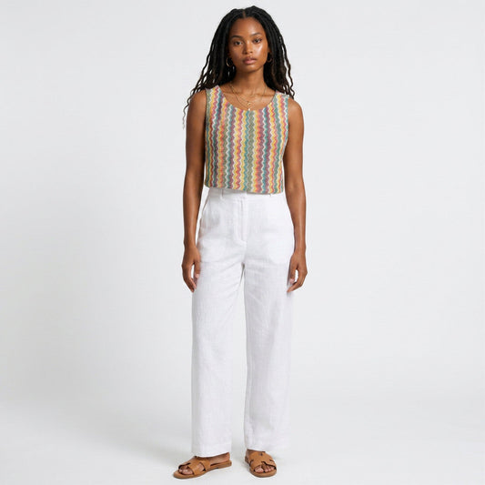 Model wearing Lynn's Closet Boutique Anthropologie Verb sleeveless top with a multi-colored chevron textured pattern.