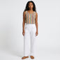 Model wearing Lynn's Closet Boutique Anthropologie Verb sleeveless top with a multi-colored chevron textured pattern.