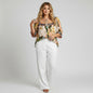 Lynn's Closet Boutique Anthropologie Verb floral pleated top with beadwork and embroidery on a model in white trousers