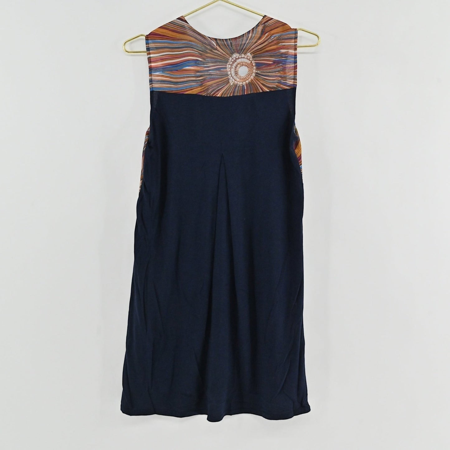 Lynn's Closet Boutique Anthropologie shift dress featuring a navy back panel with a subtle pleat and sunburst print