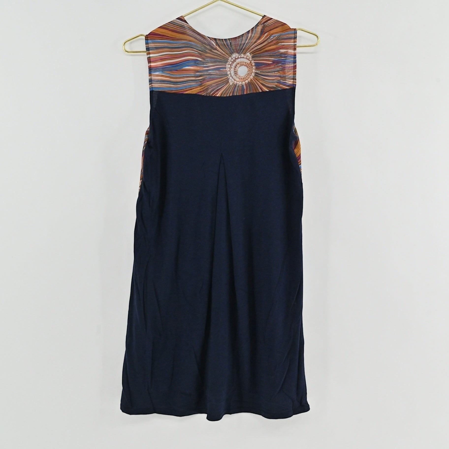 Lynn's Closet Boutique Anthropologie shift dress featuring a navy back panel with a subtle pleat and sunburst print